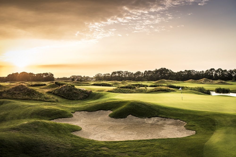 Sunset over a bunkered green at The Dutch