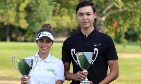 Nurtai holding the Kazakhstan Amateur Championship trophy beside the women's champion